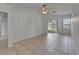 This living room has tile floors, a ceiling fan, and sliding glass doors to the backyard at 2803 Abbey Grove Dr, Valrico, FL 33594