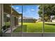 View from the screened patio out to the meticulously maintained backyard and blue skies at 2803 Abbey Grove Dr, Valrico, FL 33594