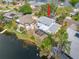 Waterfront home with screened lanai, lush landscaping, and private dock for boating and enjoying the serene water views at 320 Tallahassee Ne Dr, St Petersburg, FL 33702
