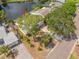 Aerial view of waterfront home with mature trees, dock, and beautifully landscaped yard at 320 Tallahassee Ne Dr, St Petersburg, FL 33702
