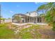 A view of the backyard, with a screened-in porch attached to the home at 320 Tallahassee Ne Dr, St Petersburg, FL 33702