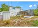 A view of the backyard, featuring a screened enclosure attached to the home's exterior at 320 Tallahassee Ne Dr, St Petersburg, FL 33702