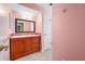 Bathroom featuring a cherry vanity with mosaic backsplash, a large mirror, and tiled floors at 320 Tallahassee Ne Dr, St Petersburg, FL 33702