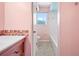 Bathroom with pink walls, mosaic tile accent, and a bathtub shower combo at 320 Tallahassee Ne Dr, St Petersburg, FL 33702