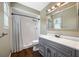 Bathroom featuring a vanity with a gray cabinet, white countertop, and a shower with white tile at 320 Tallahassee Ne Dr, St Petersburg, FL 33702