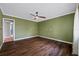 Spacious bedroom with hardwood floors, a ceiling fan, and a neutral color scheme at 320 Tallahassee Ne Dr, St Petersburg, FL 33702