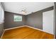 Bedroom featuring a ceiling fan, wood floors, gray walls and a window with blinds at 320 Tallahassee Ne Dr, St Petersburg, FL 33702
