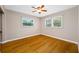 Bedroom featuring wood floors, neutral walls, and two windows with blinds letting in natural light at 320 Tallahassee Ne Dr, St Petersburg, FL 33702