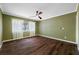 Cozy bedroom features a ceiling fan and large window letting in natural light at 320 Tallahassee Ne Dr, St Petersburg, FL 33702