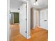 Hallway with wood flooring, leading to bedrooms and closets at 320 Tallahassee Ne Dr, St Petersburg, FL 33702
