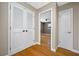 Hallway view featuring white doors and bamboo floors, leading to a room with a ceiling fan at 320 Tallahassee Ne Dr, St Petersburg, FL 33702