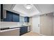 Modern kitchen highlighting navy cabinets, stainless appliances, and bright lighting at 320 Tallahassee Ne Dr, St Petersburg, FL 33702