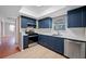 Modern kitchen featuring stainless steel appliances, subway tile backsplash, and stylish blue cabinetry at 320 Tallahassee Ne Dr, St Petersburg, FL 33702