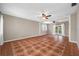 Bright living room with patterned tile floors, a ceiling fan, and natural light from the window at 320 Tallahassee Ne Dr, St Petersburg, FL 33702