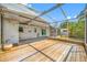 Spacious screened-in porch with wood deck, ceiling fan, and plenty of room for entertaining at 320 Tallahassee Ne Dr, St Petersburg, FL 33702