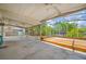 A large screened-in porch with a view of the home's lushly landscaped backyard and canal at 320 Tallahassee Ne Dr, St Petersburg, FL 33702