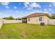 A well-maintained backyard featuring lush green grass and surrounded by white vinyl fencing at 3302 Granite Ridge Loop, Land O Lakes, FL 34638