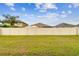 Expansive backyard enclosed with white fencing, providing privacy and security for outdoor activities at 3302 Granite Ridge Loop, Land O Lakes, FL 34638