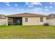 Lush backyard featuring a covered patio perfect for entertaining, set against white vinyl fencing at 3302 Granite Ridge Loop, Land O Lakes, FL 34638