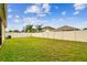 Expansive backyard enclosed with white fencing and partial view of home exterior, perfect for outdoor living at 3302 Granite Ridge Loop, Land O Lakes, FL 34638