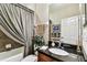 Bathroom with dark granite counters and a curtained shower at 3302 Granite Ridge Loop, Land O Lakes, FL 34638