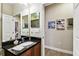 Bathroom featuring dark granite counters, modern fixtures, and stylish décor at 3302 Granite Ridge Loop, Land O Lakes, FL 34638