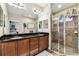 Bathroom featuring double sink vanity with dark cabinets and granite counters at 3302 Granite Ridge Loop, Land O Lakes, FL 34638