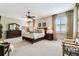Spacious main bedroom features a ceiling fan, neutral carpet and curtains at 3302 Granite Ridge Loop, Land O Lakes, FL 34638