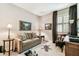 Bedroom featuring a neutral sofa, a window with shutters and an area rug at 3302 Granite Ridge Loop, Land O Lakes, FL 34638