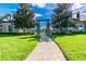 Stone gate leading to a community with beautiful landscaping and stately entrance at 3302 Granite Ridge Loop, Land O Lakes, FL 34638