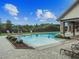 Sparkling community pool with comfortable lounge chairs and a covered area at 3302 Granite Ridge Loop, Land O Lakes, FL 34638