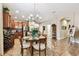Cozy dining area with decorative light fixture and tile flooring at 3302 Granite Ridge Loop, Land O Lakes, FL 34638