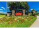 Stonegate community entrance featuring a colorful flowerbed and lush landscaping at 3302 Granite Ridge Loop, Land O Lakes, FL 34638