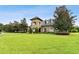 Beautiful home with lush landscaping, a well-manicured lawn, and mature trees at 3302 Granite Ridge Loop, Land O Lakes, FL 34638