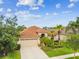 Lovely single-story home with a tan exterior, a well-manicured lawn, and mature landscaping at 3302 Granite Ridge Loop, Land O Lakes, FL 34638