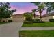 Charming one-story home with a two-car garage and beautiful lawn under a colorful sky at 3302 Granite Ridge Loop, Land O Lakes, FL 34638