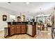 Open kitchen area with black countertops, stainless steel appliances, and dining area views at 3302 Granite Ridge Loop, Land O Lakes, FL 34638