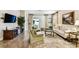 Comfortable living room with a large TV, tile floors, and sliding glass door to the outside at 3302 Granite Ridge Loop, Land O Lakes, FL 34638