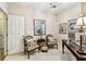 Inviting office space with seating area, featuring neutral walls and a bright interior door at 3302 Granite Ridge Loop, Land O Lakes, FL 34638