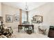 Comfortable office space featuring neutral walls, a chandelier, and a large desk at 3302 Granite Ridge Loop, Land O Lakes, FL 34638