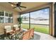Covered patio with a ceiling fan, chairs, and a view of the well-maintained backyard at 3302 Granite Ridge Loop, Land O Lakes, FL 34638