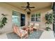 Covered patio with comfortable seating and a view of the backyard at 3302 Granite Ridge Loop, Land O Lakes, FL 34638