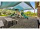 A shaded community playground with slides, climbing equipment, and a picnic table at 3302 Granite Ridge Loop, Land O Lakes, FL 34638