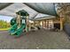 A shaded community playground with slides, climbing structures, and a picnic table at 3302 Granite Ridge Loop, Land O Lakes, FL 34638