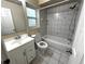 This is a bathroom with a toilet, tub, shower, sink, and mirror at 3419 Pearson Rd, Valrico, FL 33596