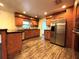 Well-lit kitchen with granite counters, wooden cabinets, and stainless steel appliances at 3419 Pearson Rd, Valrico, FL 33596