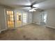 Living room featuring neutral walls, carpeted flooring, ceiling fan and french doors at 3419 Pearson Rd, Valrico, FL 33596