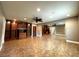 This living room features built-in shelving, ceiling fan, vinyl flooring and a mirrored wall at 3419 Pearson Rd, Valrico, FL 33596
