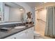 Well-maintained bathroom featuring a granite countertop, vanity, and tiled walk-in shower at 36750 Us 19 N # 24-213, Palm Harbor, FL 34684