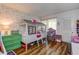 Stylish bedroom with a flamingo theme, fun striped bedframe, and wood-look flooring at 36750 Us 19 N # 24-213, Palm Harbor, FL 34684